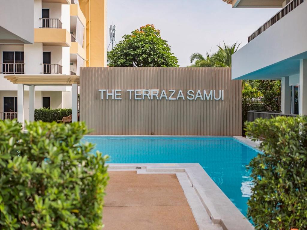 a swimming pool in front of a building at The Terraza Condotel in Nathon Bay