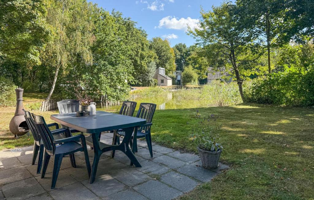a blue table and chairs in a yard at Cozy Home In Hoeven With Wifi in Hoeven