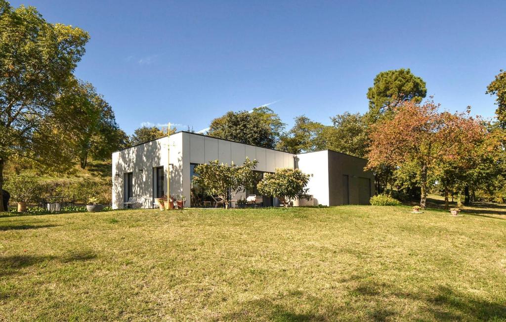 a building on a field in front of a park at Maison Avec Piscine Et Jacuzzi in Allex
