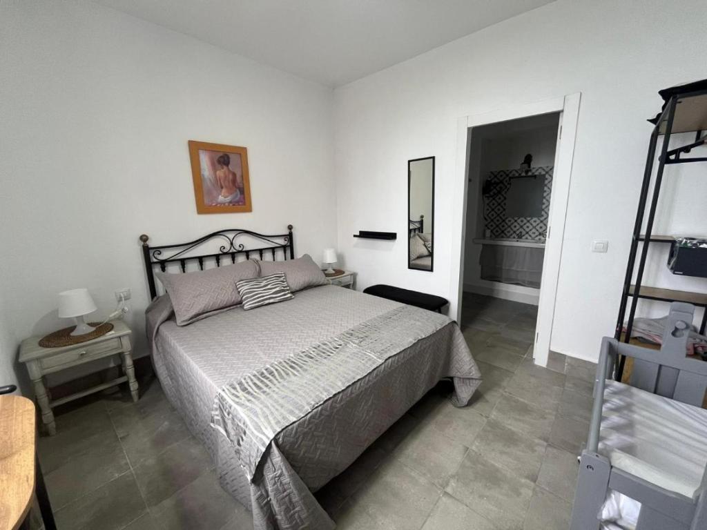 a bedroom with a large bed in a white room at Gar House in Caleta de Interián