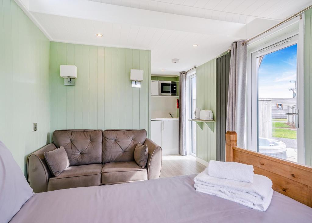 a bedroom with a bed and a chair and a window at South View Retreat in Carlton