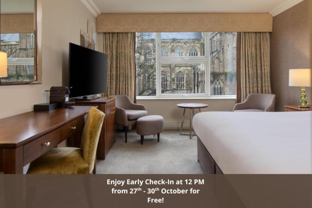 a hotel room with a bed and a desk and a television at Winchester Wessex Hotel by Sunday in Winchester
