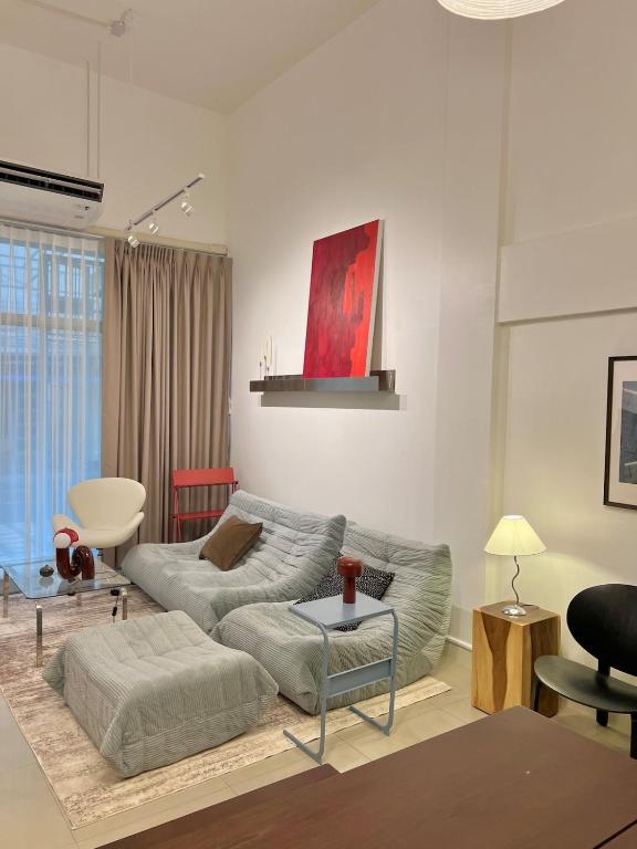 a living room with a couch and a table at Roni House Thonglor in Bangkok