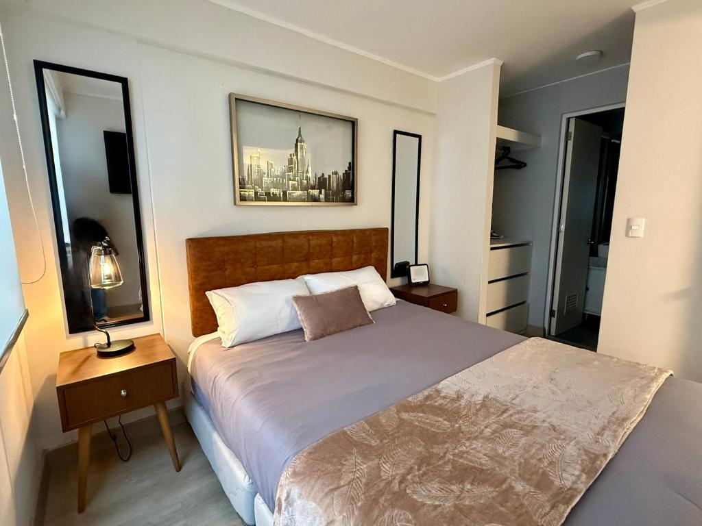 a bedroom with a large bed and two windows at Departamento Osma in Lima