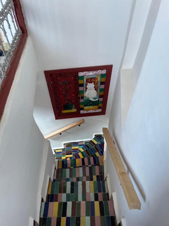 a stair case with a colorful carpet on it at Riad la Mentha in Fès