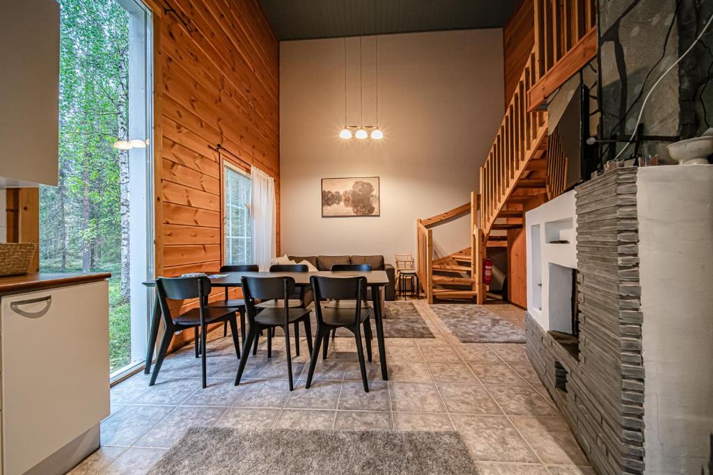 a kitchen and dining room with a table and chairs at Aurelfox Chalet A by Aavalevi in Levi