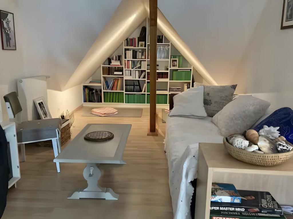 a living room with a couch and a table at Chambre d'hotes à Laroin in Laroin
