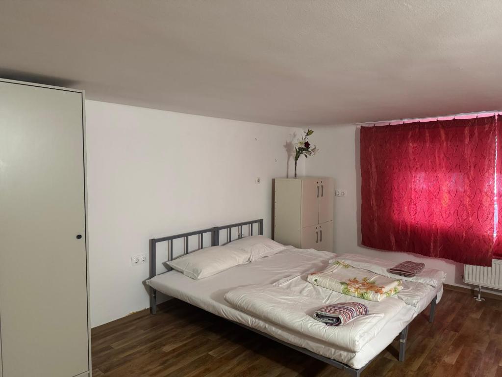 a bedroom with a bed with a red curtain at Opera Central Stay in Budapest