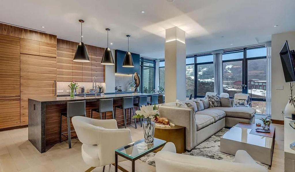 a living room with a couch and a kitchen at Modern Alpine Escape Sophistication in Snowmass in Snowmass Village