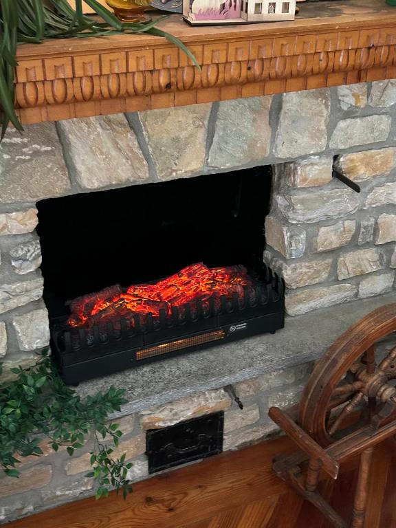 a large stone fireplace with a fire in it at Casa Rita in Bormio