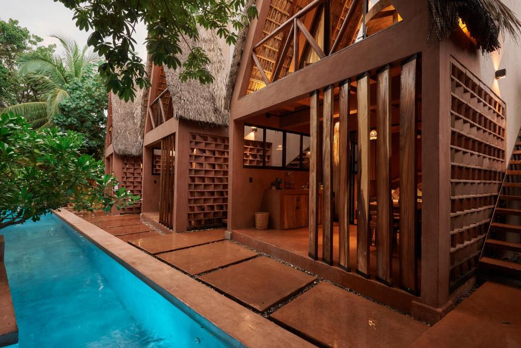 a house with a swimming pool next to a building at Punta Navi - Adults only - Boutique hotel in Puerto Escondido