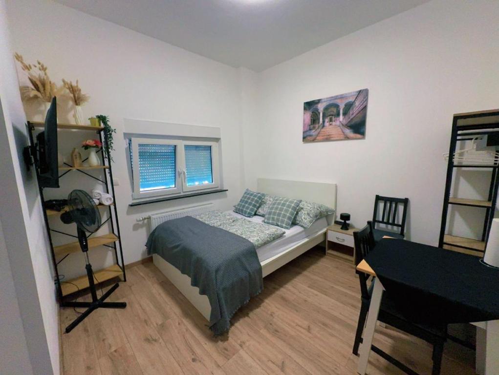a bedroom with a bed and a desk and a laptop at Easy Stay Koblenz in Koblenz