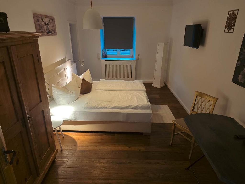a small bedroom with a bed and a window at Gasthof Staudham in Wasserburg am Inn