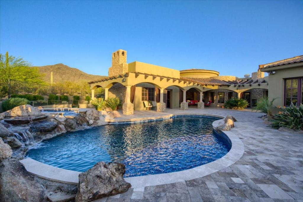 a swimming pool in the backyard of a house at Romantic 4BR Hacienda with Pool, Spa and Close to Town in Cave Creek