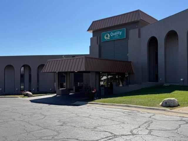 a building with a sign for a parking lot at Quality Inn By Choice Hotels - West Des Moines - I 235 & I 80 in West Des Moines