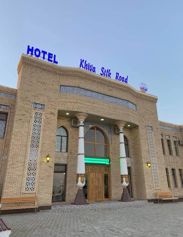 a brick hotel with a sign on top of it at Khiva Silk Road in Khiva