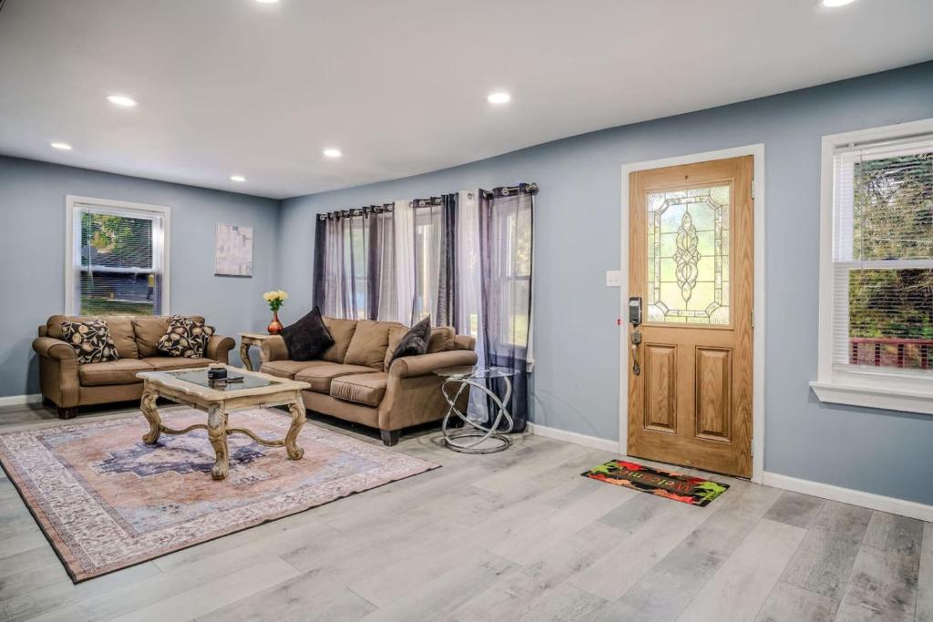 a living room with two couches and a table at Mineola Bay Lakeview and Access Fully Furnished Monthly and Seasonal Rental in Fox Lake in Fox Lake