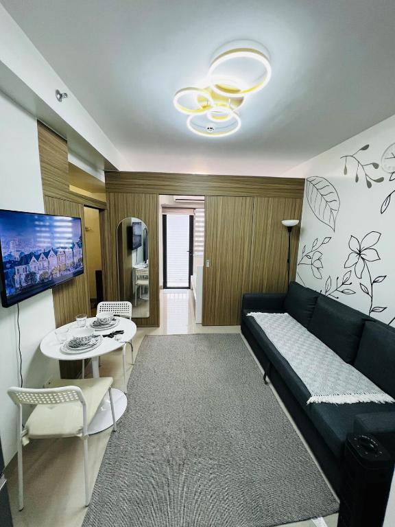 a living room with a couch and a table at MOA GRAND STAY Suite 03 Spacious Unit ! in Manila