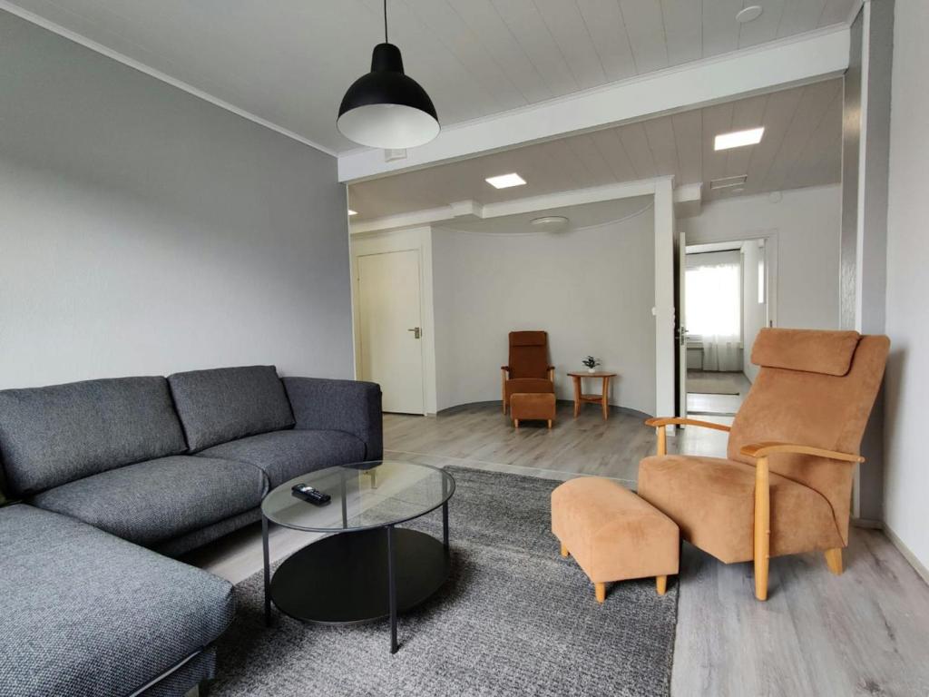 a living room with a couch and a table at Central and Spacious Apartment for 11 in Kemi