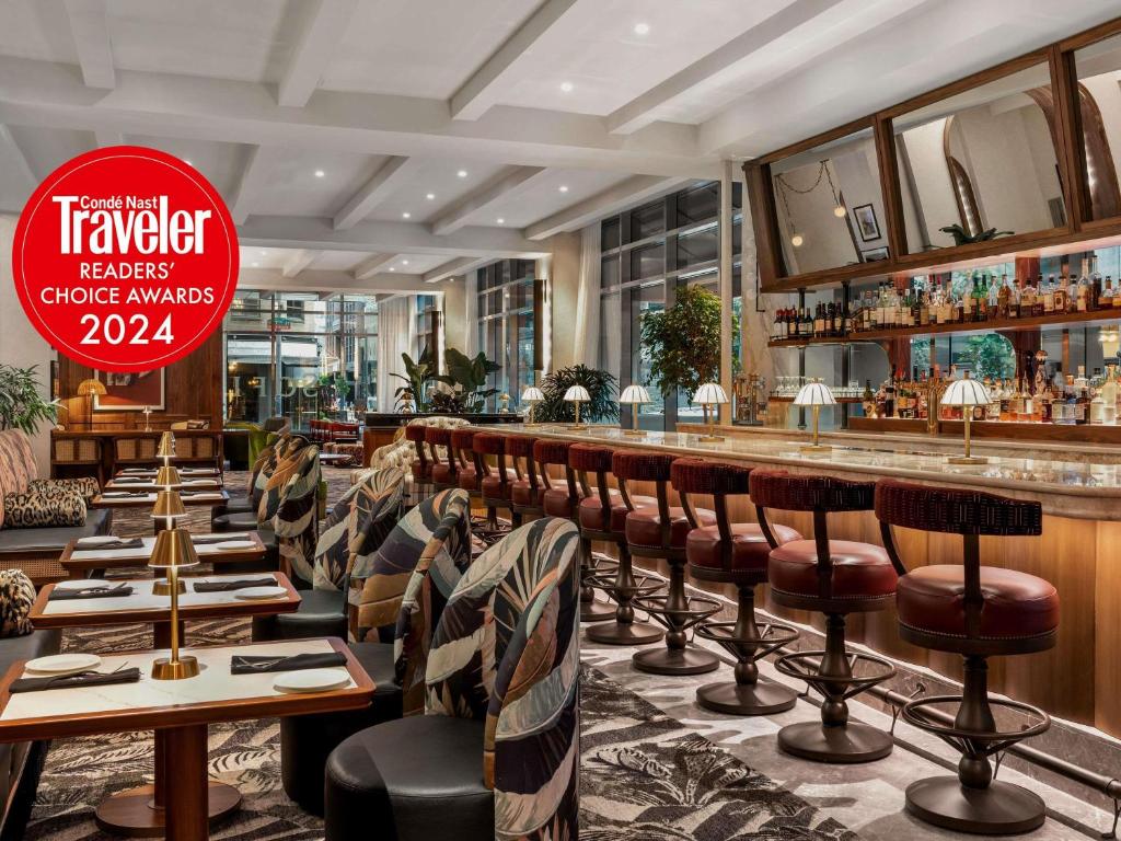 a restaurant with a bar with chairs and a sign that reads traveleraea garage awards at Sofitel Philadelphia at Rittenhouse Square in Philadelphia