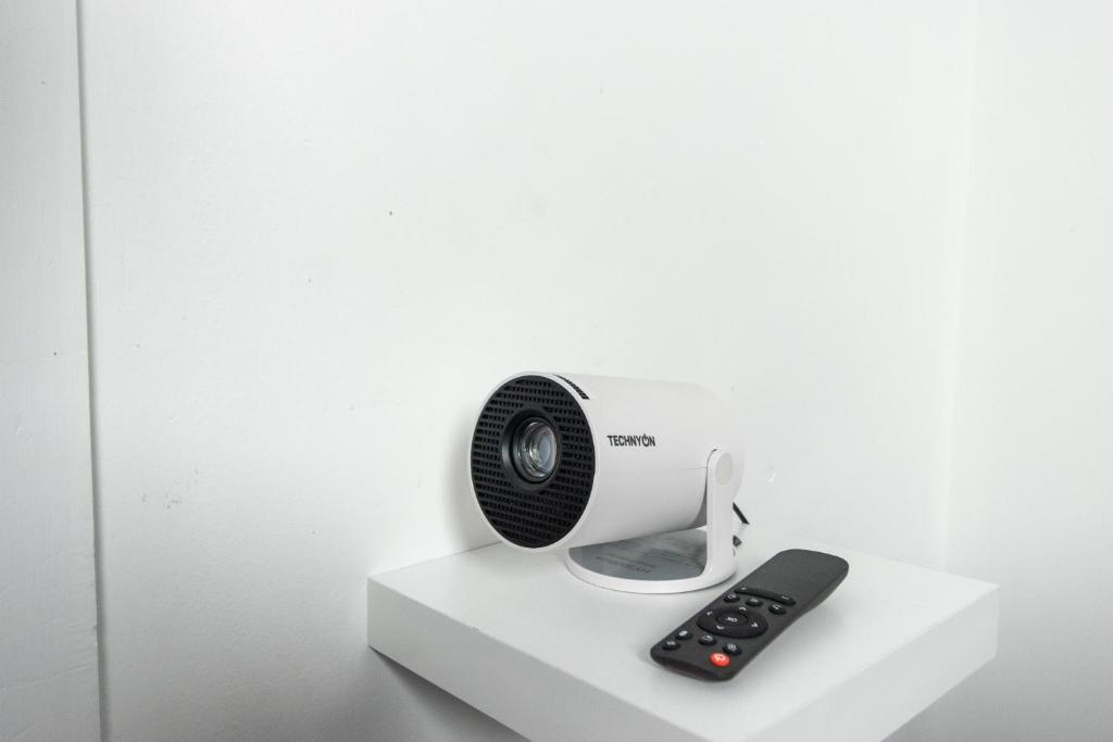 a white heater and a remote control on a shelf at Stylish 3 BD | Prime Location | Fast train to London in Bickley