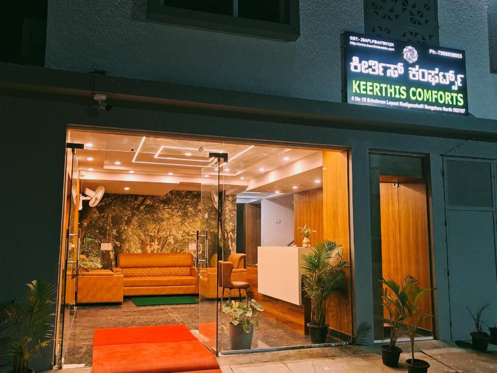 an entrance to akerskus contracts office with orange furniture at Keerthis Comforts -Near Kemegowda international Airport Hotel in Bengaluru