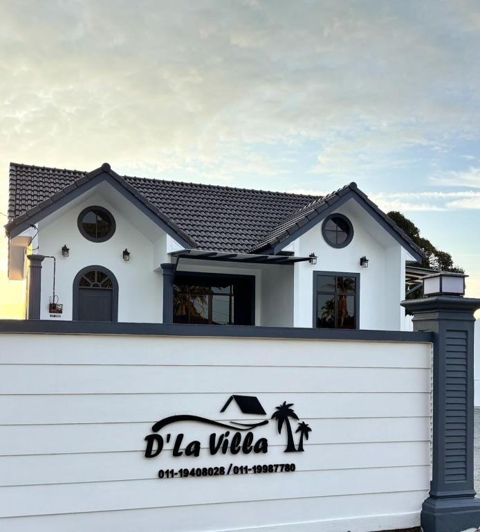 a white house behind a white fence at D'La Villa Homestay in Jertih