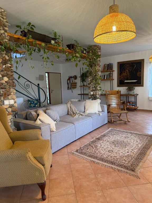 a living room with a blue couch and chairs at Country house in Golan in Kidmat Tsvi