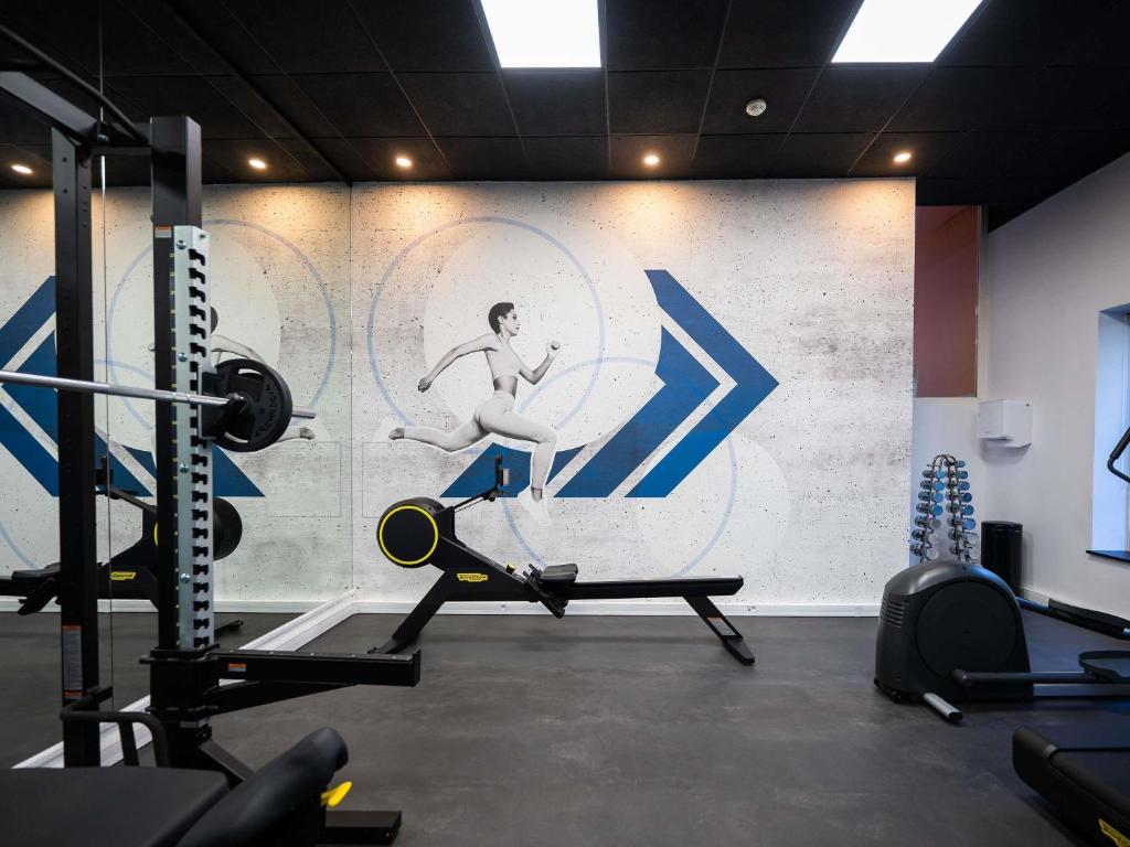 a gym with a mural of a man running on a treadmill at Novotel Praha Wenceslas Square in Prague