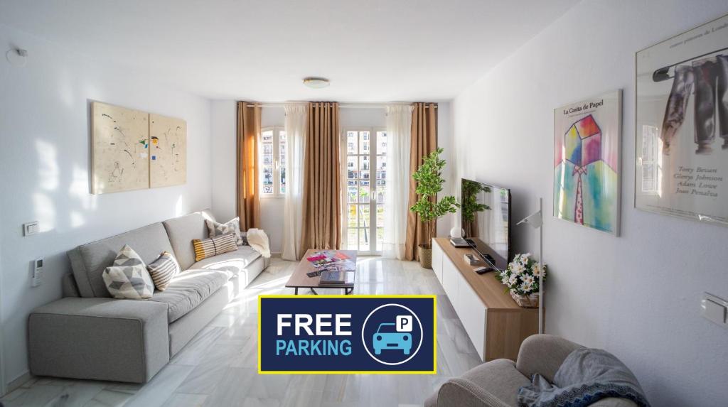 a living room with a free parking sign in it at Cozy central apartment with FREE parking in Málaga