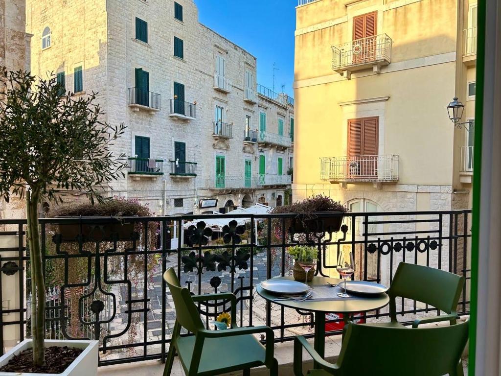 a patio with a table and chairs on a balcony at Blu Marina Apartment in Giovinazzo