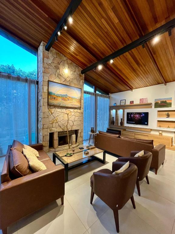 a living room with a couch and a fireplace at Casa Vovó Vadé in Palmeiras