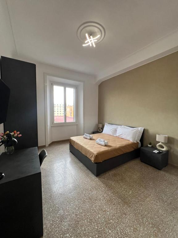 a bedroom with a large bed and a window at Galaxy Colosseum Apartment - a 450m dal Colosseo in Rome