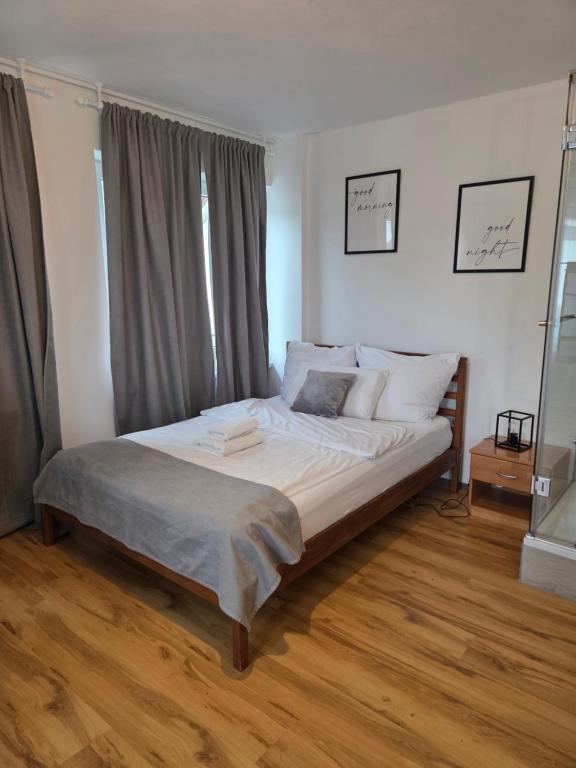 a bedroom with a large bed with white sheets and pillows at Kleine Zimmer in Gästehaus in Feldkirch
