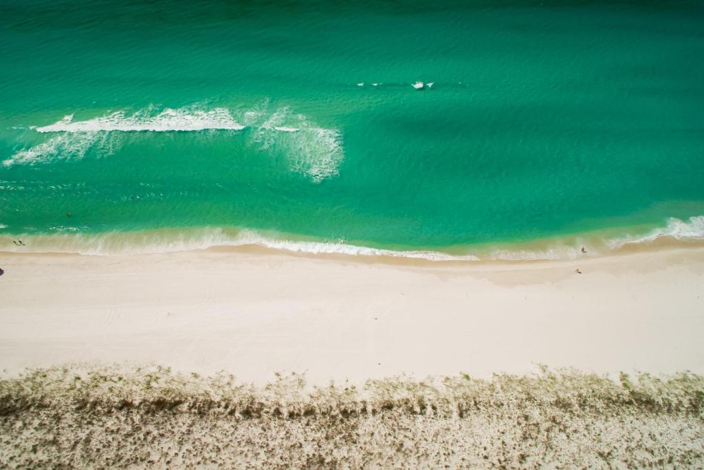 an overhead view of the ocean and a beach at Quaint 2BR/25BA Cottage Nestled Between 30A & Panama City Beach! Sleeps 6! in Carillon Beach