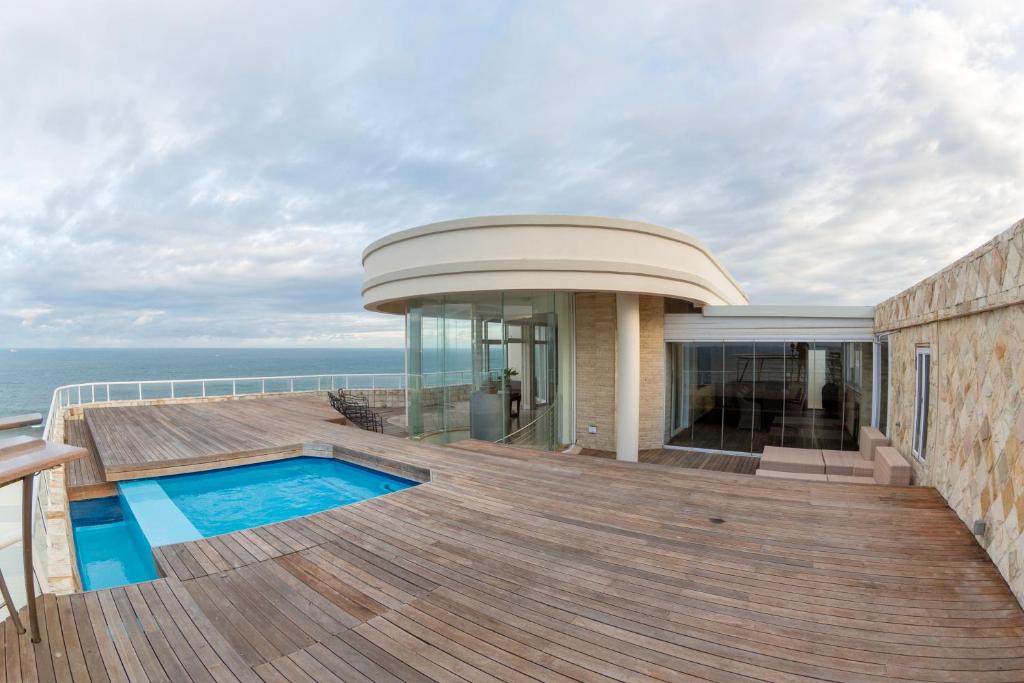 a house with a deck with a swimming pool at Unit 1101 Oyster Rock in Durban