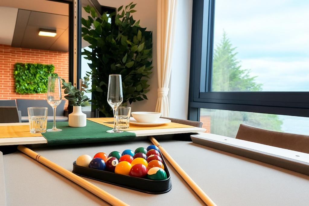 a table with chopsticks and a tray of colorful balls at Brand-New Luxury Apartment Terrace - Opposite Piccadilly Line - 1-8 Guests in Uxbridge