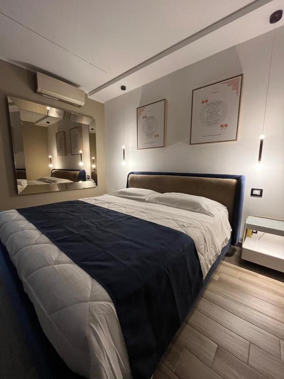 a bedroom with a large bed and a mirror at Omero in Reggio di Calabria
