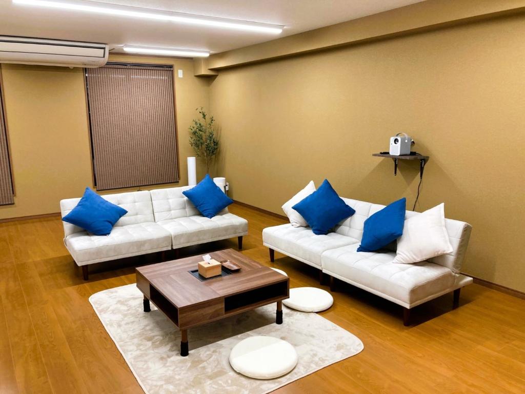 a living room with two white couches and blue pillows at Wakayama - House - Vacation STAY 64124v in Wakayama