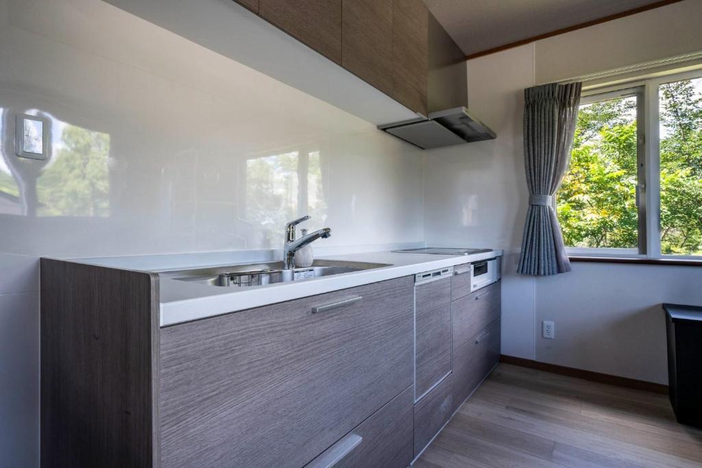 a kitchen with a sink and a window at NISEKO Mt,Village - Vacation STAY 65414v in Kaributo