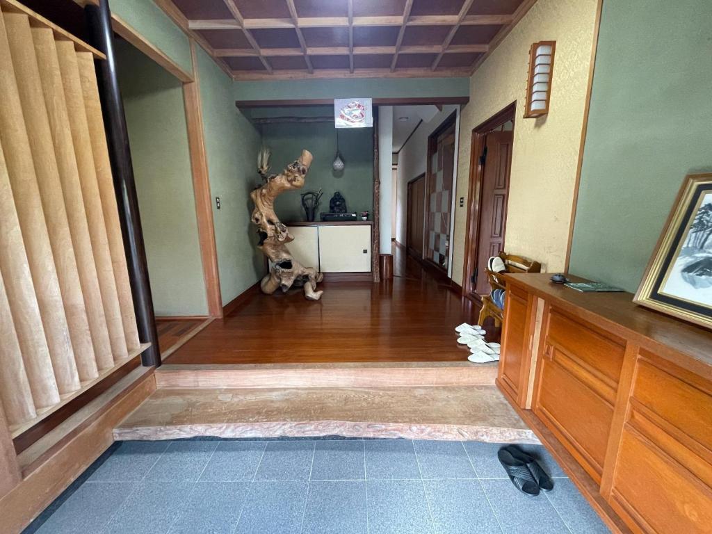 a hallway with a room with a dinosaur on the wall at Tawaraya-Traditional Japanese-style Inn - Vacation STAY 73840v in Shimo-tahara