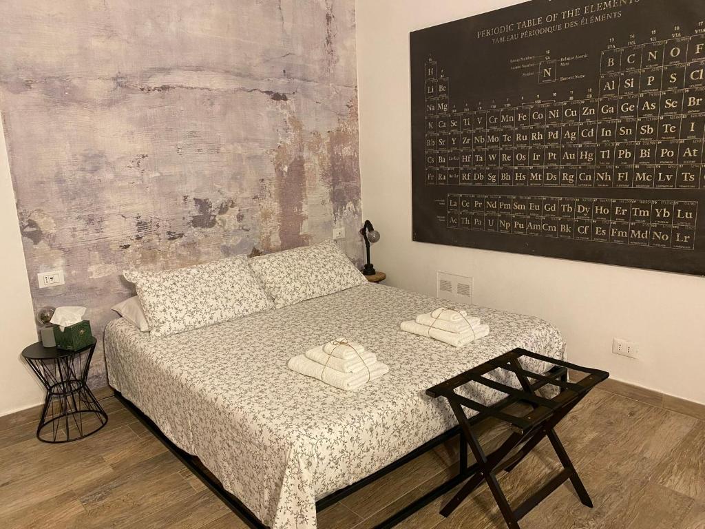 a bedroom with a bed with two towels on it at Chagall Charme in Asti