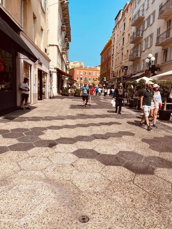a group of people walking down a city street at Sweethome Massena in Nice