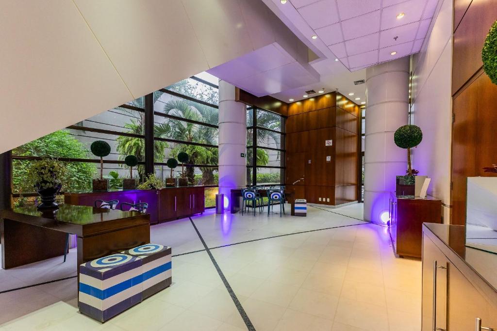 a lobby with purple lighting in a building at Flats Hotel Paulista | Delfhy in São Paulo