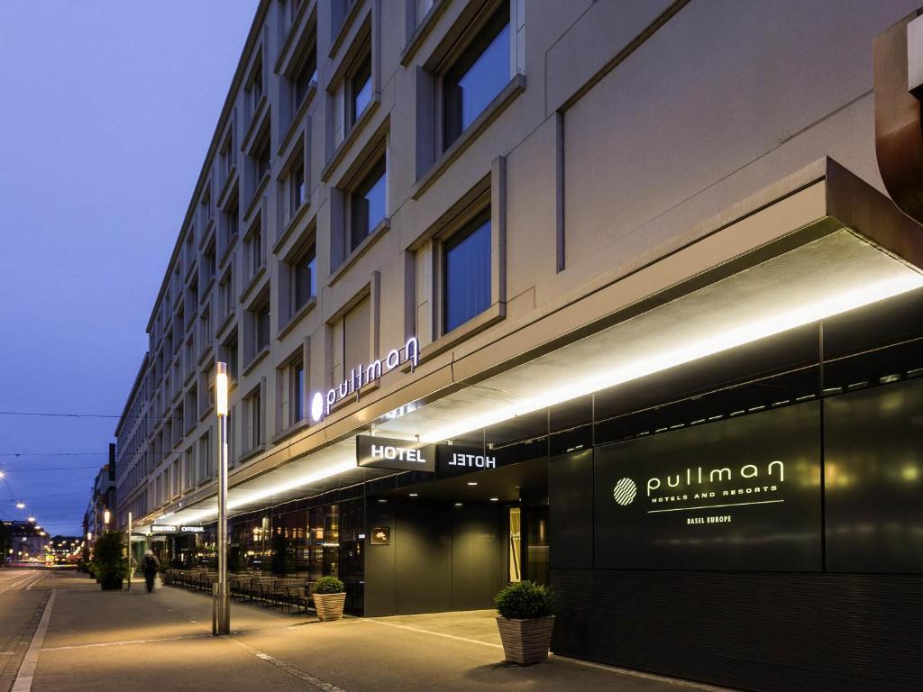 a building with lights on the side of a street at Pullman Basel Europe in Basel