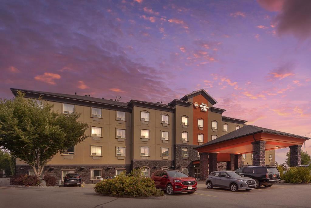 a hotel with cars parked in a parking lot at Best Western Plus St Albert in St. Albert