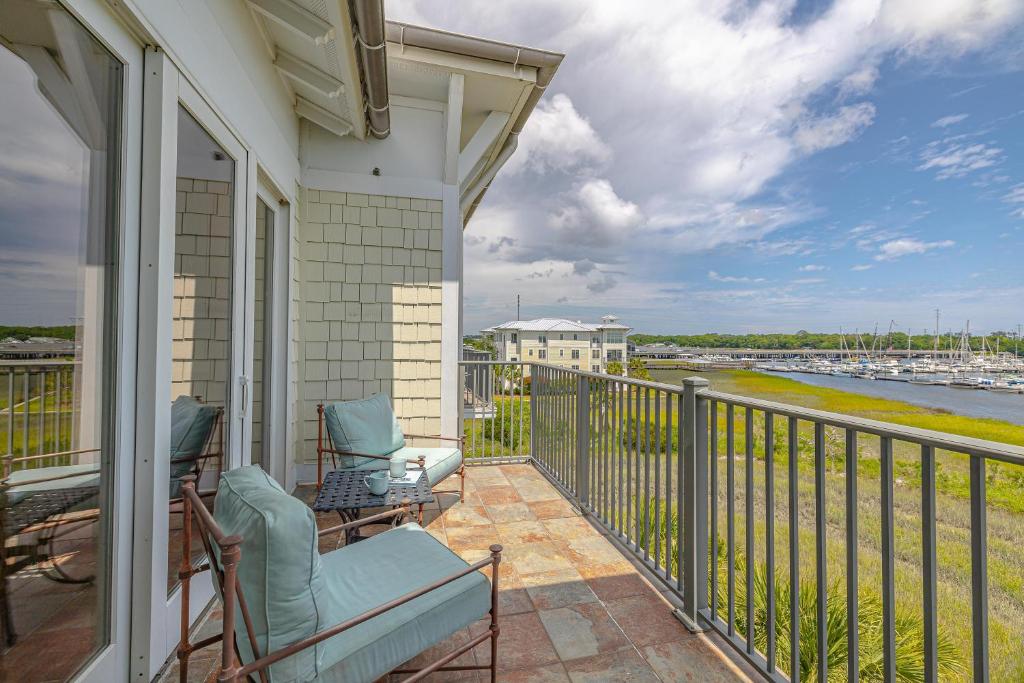 a balcony with chairs and a view of the water at 10 Waterfront Drive, #312 in Saint Simon Mills