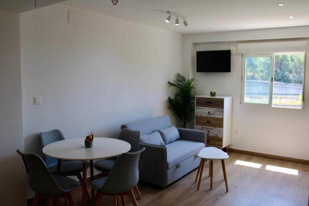 a living room with a couch and a table at Estudio Finca Mas el Bravo in Caudiel