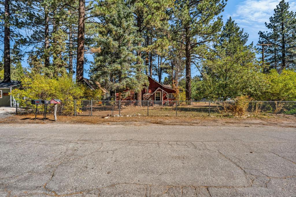 a house with a fence in front of a yard at Green Cabin in Big Bear Lake 3 bdr Pets Friendly in Big Bear City