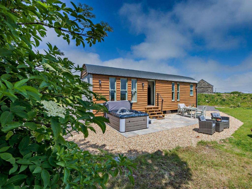 a log cabin with a deck and a patio at 1 Bed in Boscastle 95316 in Camelford